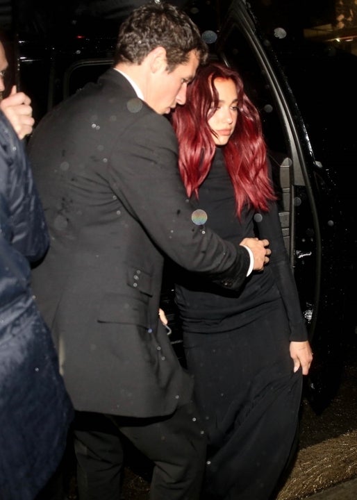 Dua Lipa and Boyfriend Callum Turner brave the rain while attending a Grammys after-party at the Chateau Marmont in Los Angeles.